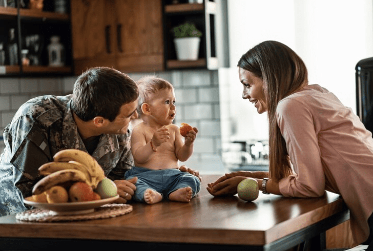 Military family spending time together with while healthy fruits